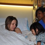 Elise and our awesome labor and delivery nurse, Raquel, peeking at Maggie