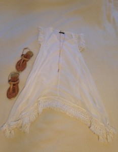 White sleeveless fringe dress and nude sandals